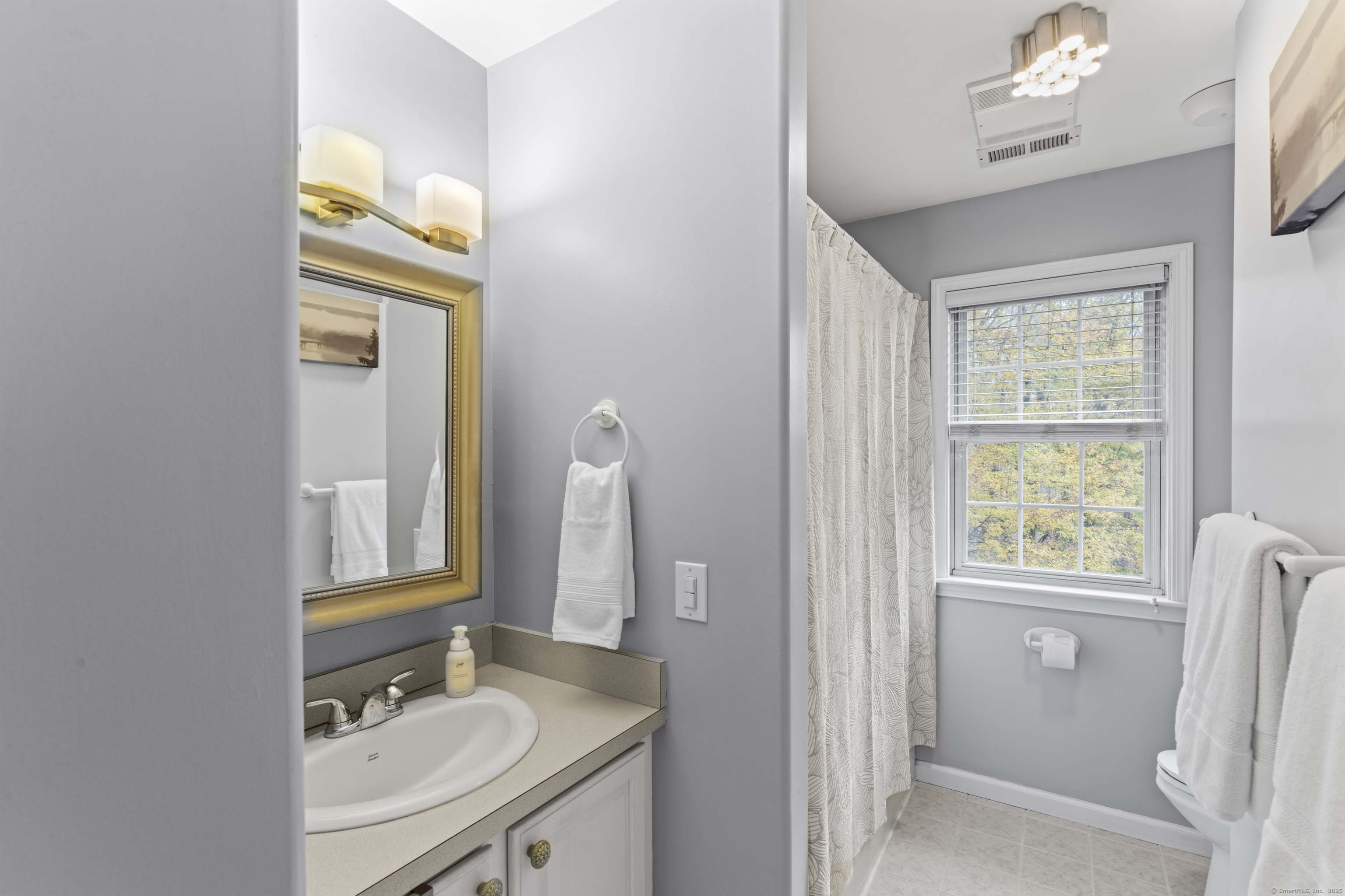 22 Lincoln Road Newtown, CT 06470 - Photo 19 of 36 a bathroom with a sink a vanity and a mirror