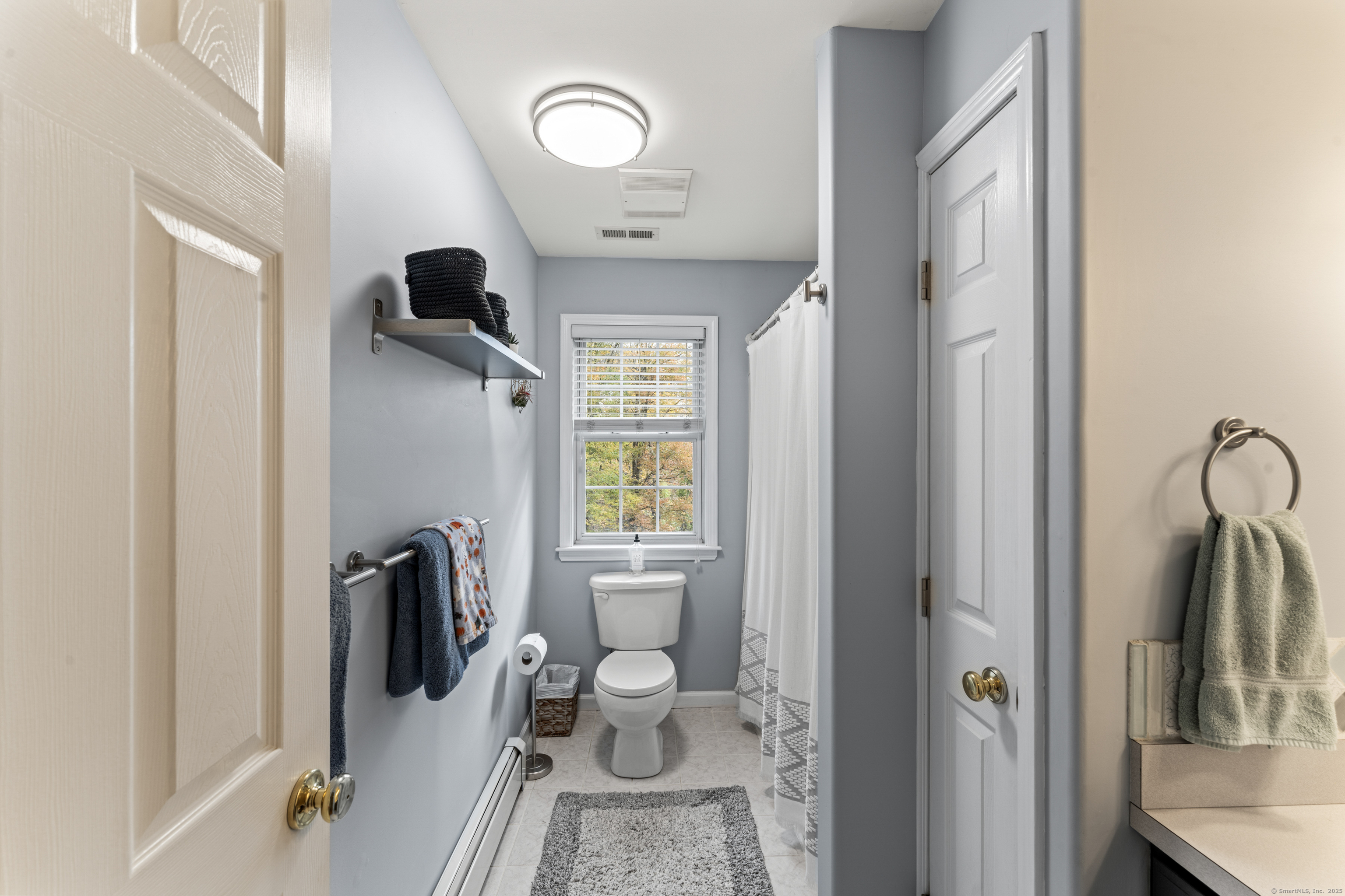 22 Lincoln Road Newtown, CT 06470 - Photo 21 of 36 a living room with furniture a flat screen tv and a window