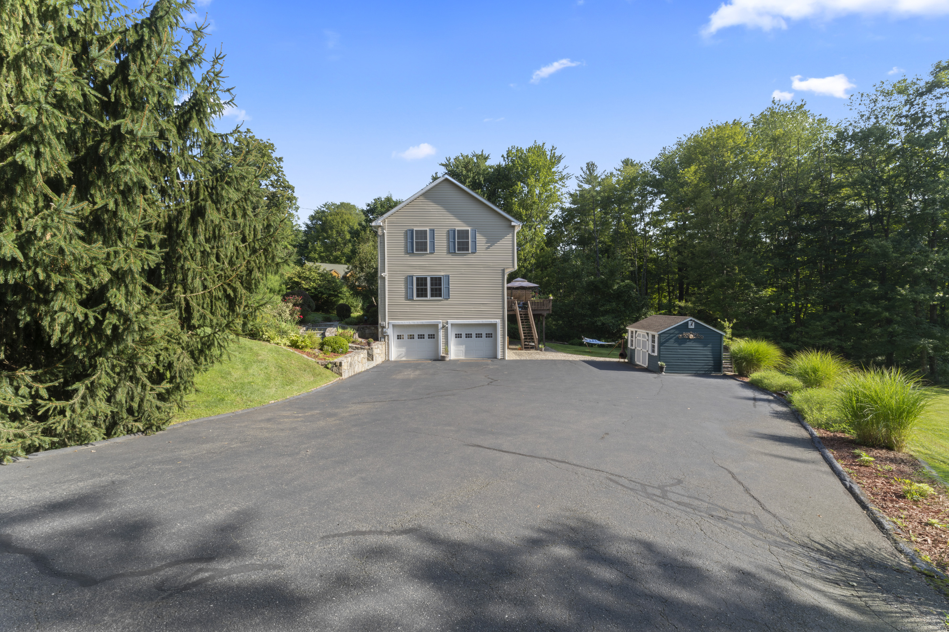 22 Lincoln Road Newtown, CT 06470 - Photo 33 of 36 a front view of a house with a yard and garage