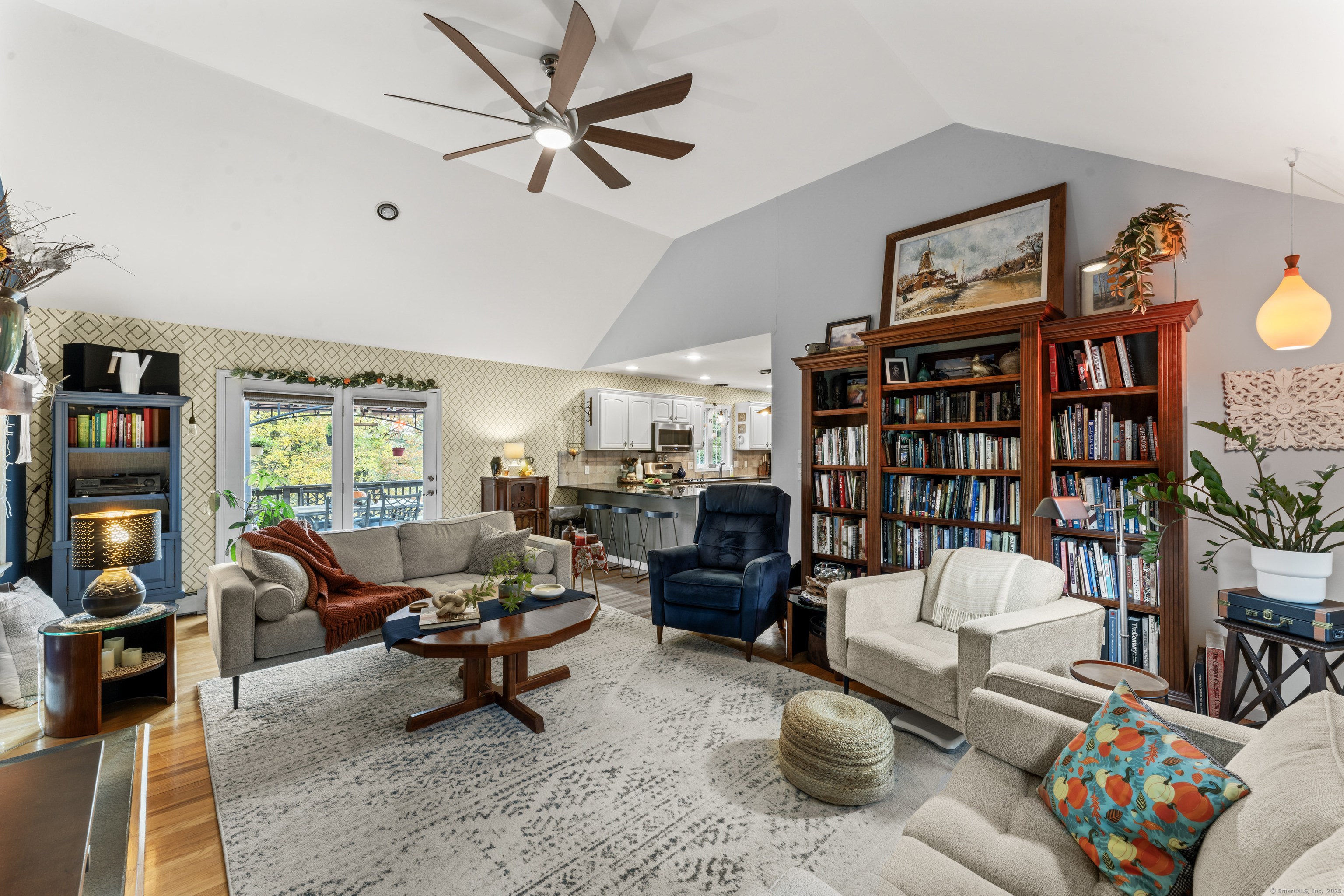 22 Lincoln Road Newtown, CT 06470 - Photo 10 of 36 a living room with furniture a bookshelf and a large window