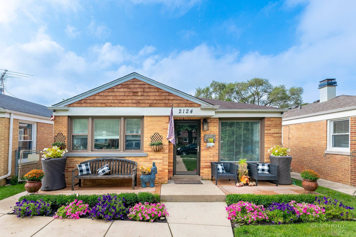 2124 Seward Street Evanston, IL 60202 - Photo 1 of 27 a front view of a house with lots of flowers around