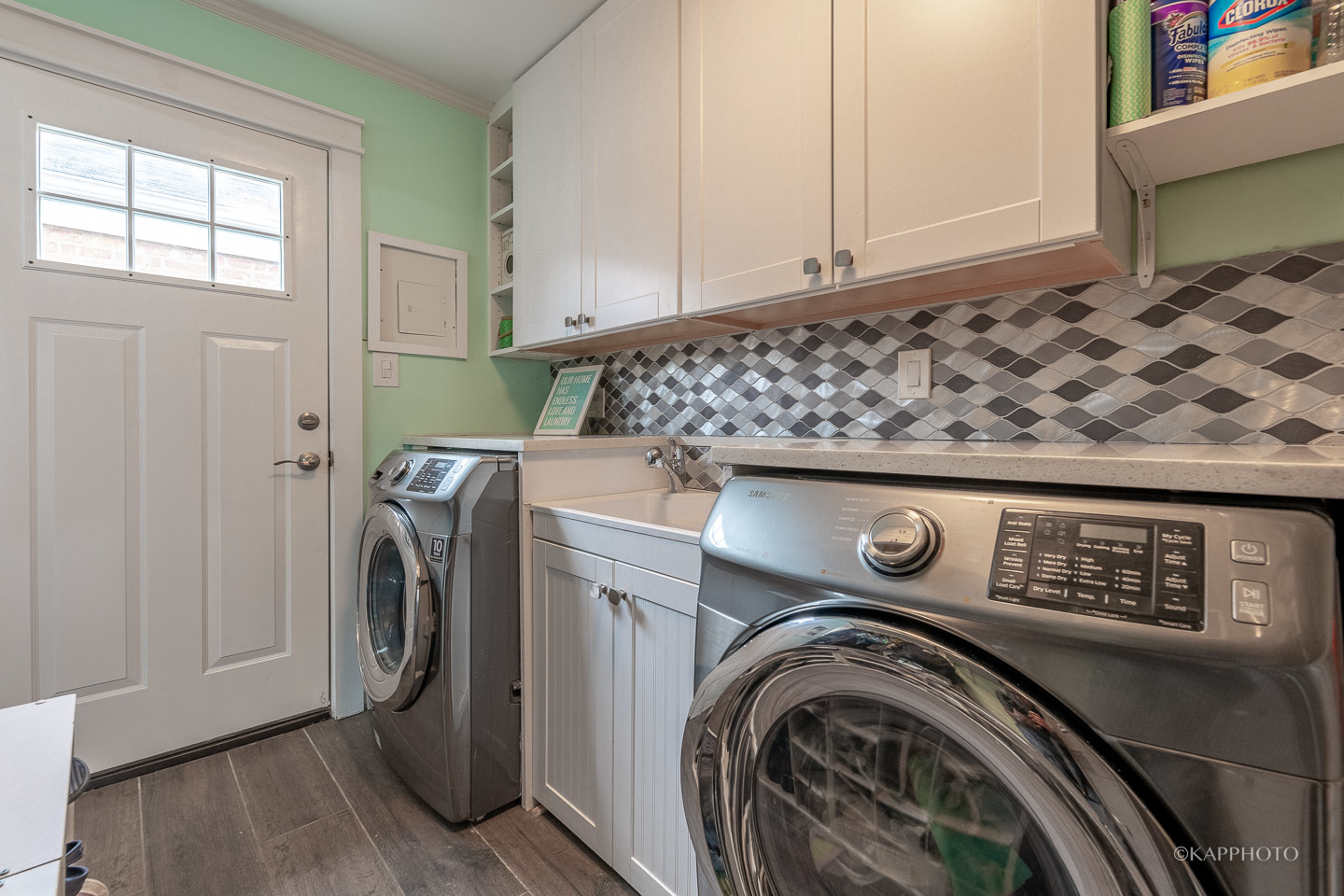 2124 Seward Street Evanston, IL 60202 - Photo 12 of 27 a view of washer and dryer with kitchen in the background