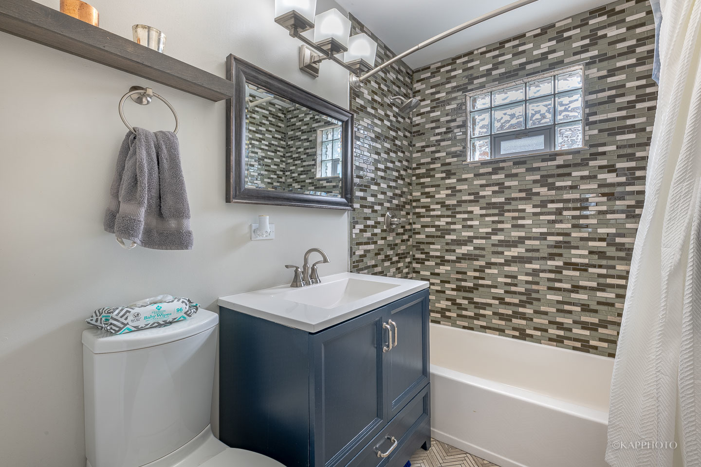 2124 Seward Street Evanston, IL 60202 - Photo 21 of 27 a bathroom with a sink a toilet and shower