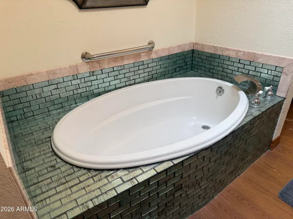 a bathroom with a bathtub and mirror