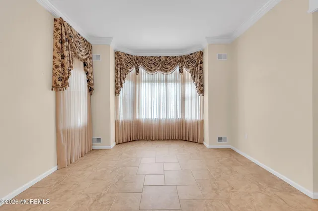 a view of an empty room with a fireplace and a window