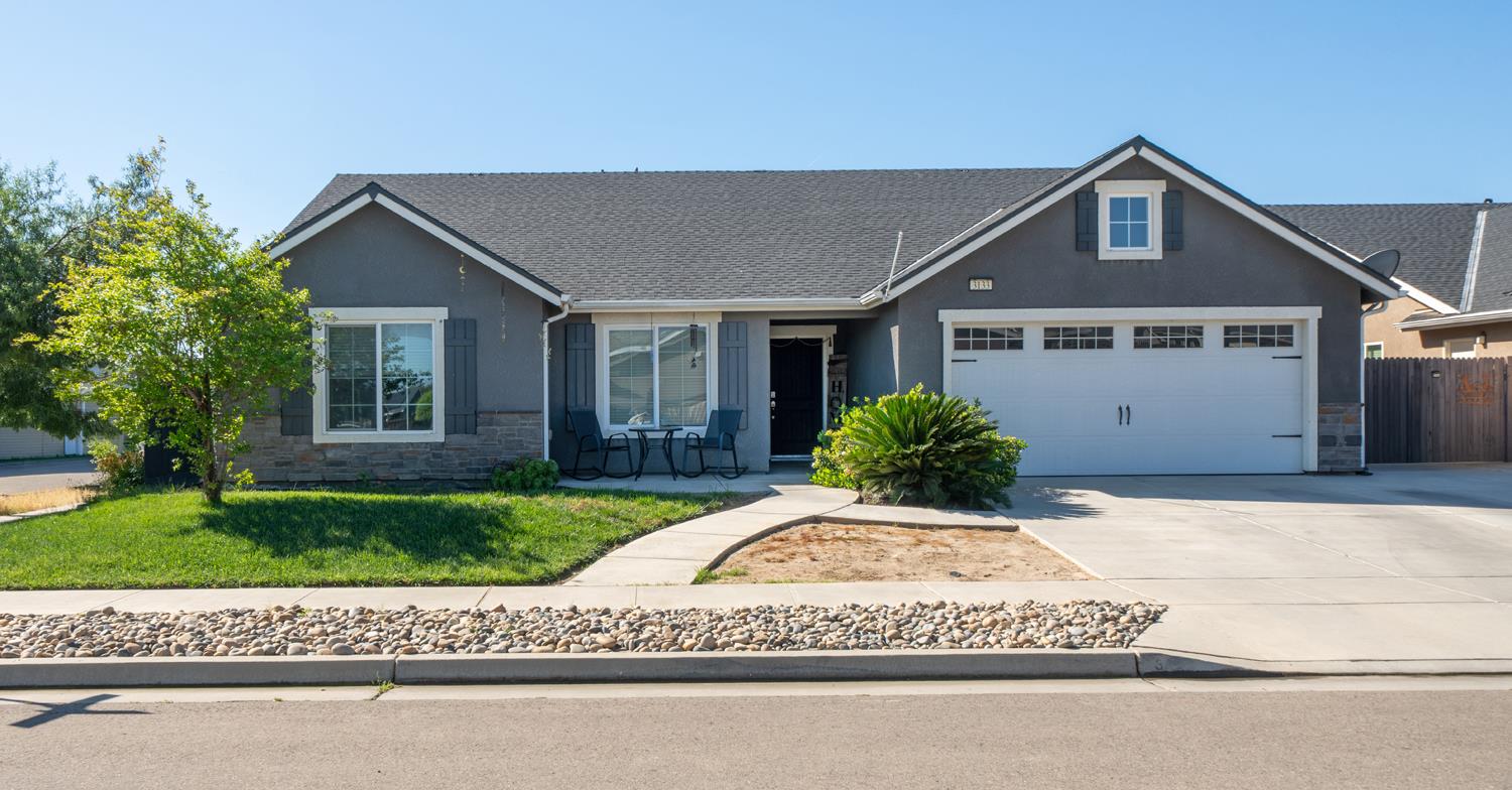 a view of front of house with a yard
