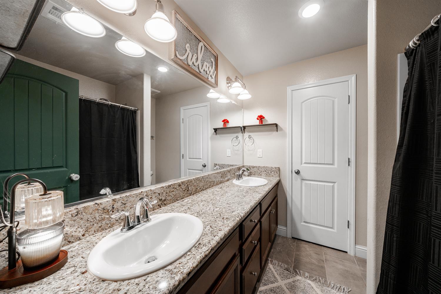3133 4th Street Sanger, CA 93657 - Photo 23 of 33 a en suite bathroom with a granite countertop sink and a mirror
