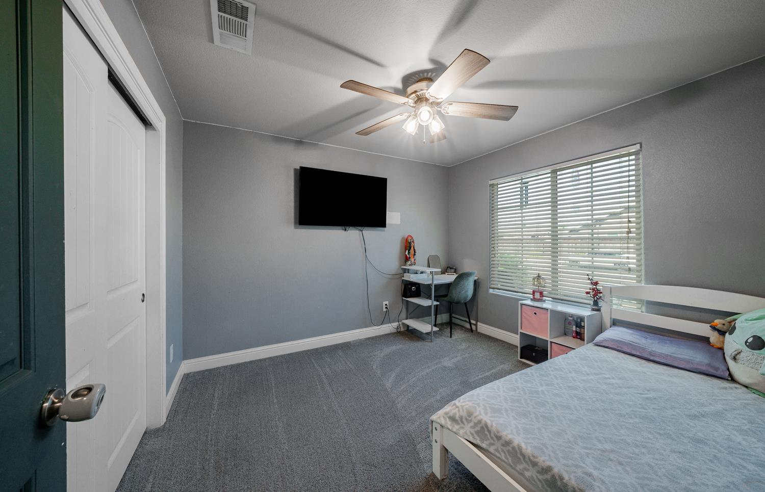 3133 4th Street Sanger, CA 93657 - Photo 24 of 33 a spacious bedroom with a bed and a flat screen tv