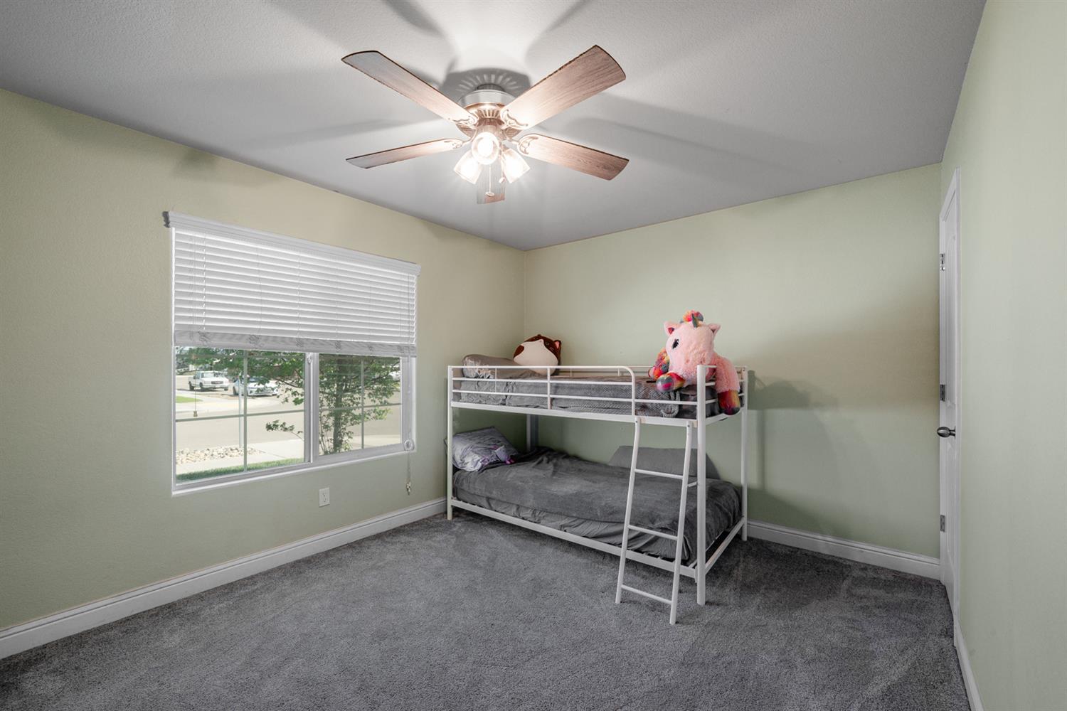 3133 4th Street Sanger, CA 93657 - Photo 25 of 33 a bedroom with bed and a chandelier