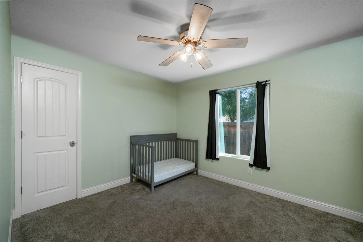 3133 4th Street Sanger, CA 93657 - Photo 26 of 33 an empty room with fan and windows