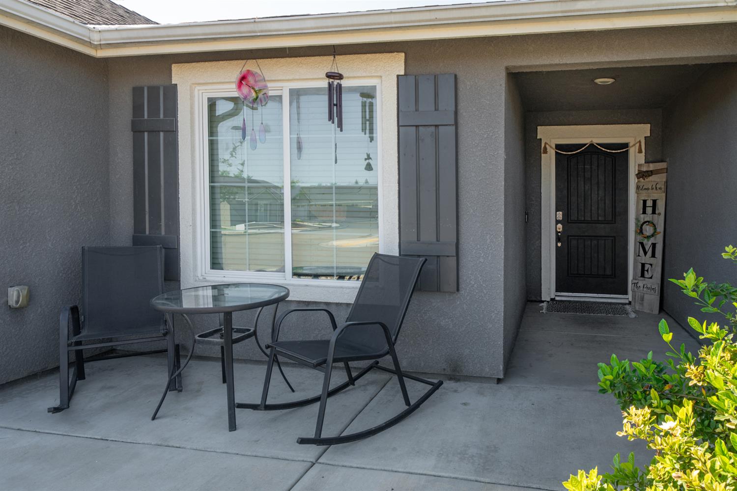 3133 4th Street Sanger, CA 93657 - Photo 4 of 33 a balcony with table and chairs and potted plants