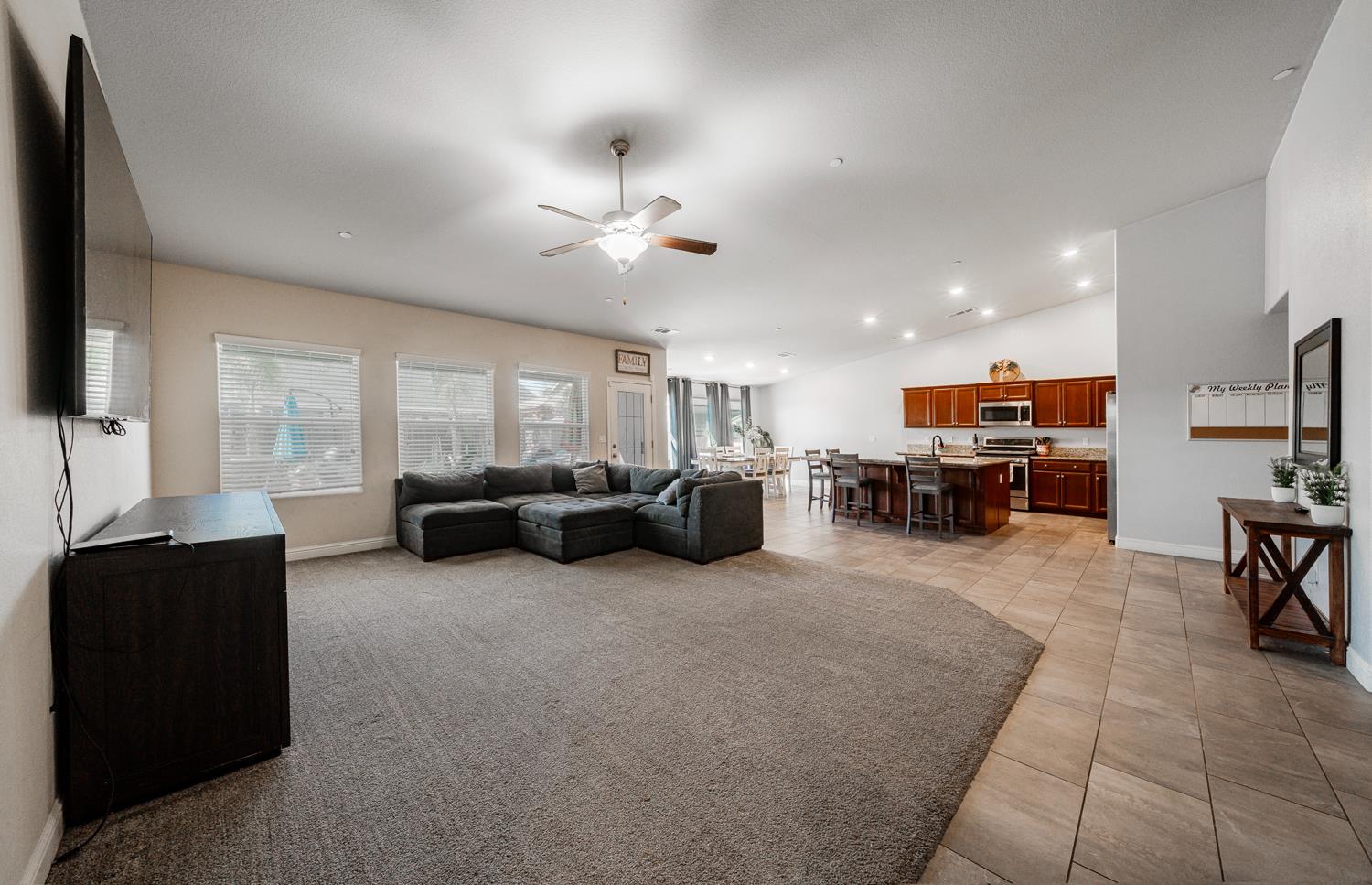 3133 4th Street Sanger, CA 93657 - Photo 7 of 33 a living room with furniture kitchen view and a flat screen tv