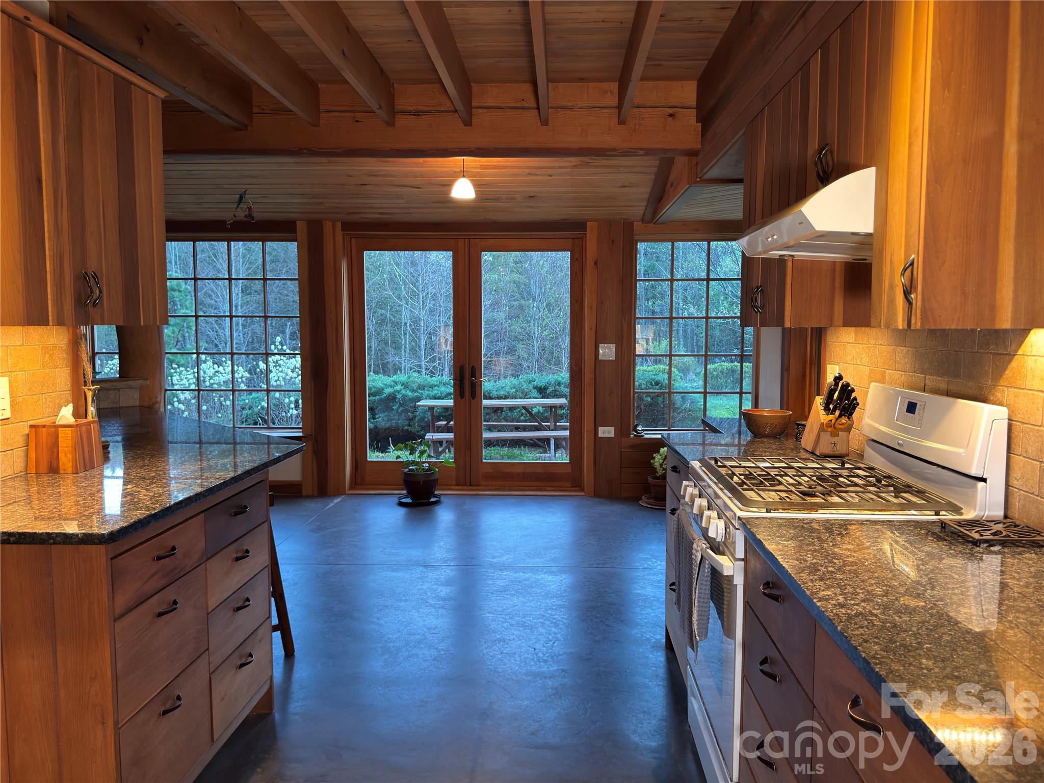 1422 Middle Fork Road Hendersonville, NC 28792 - Photo 13 of 48 a kitchen with stainless steel appliances granite countertop a stove and a wooden floors
