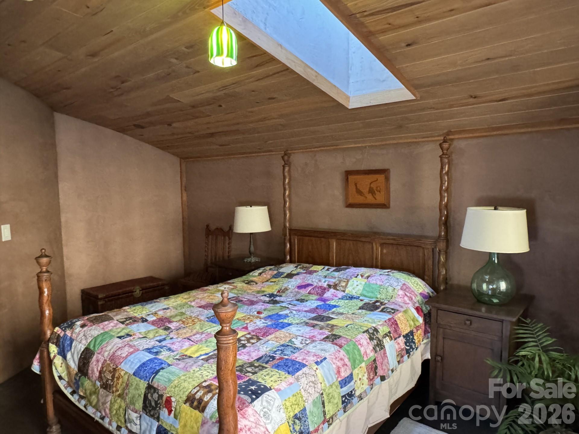 1422 Middle Fork Road Hendersonville, NC 28792 - Photo 20 of 48 a bedroom with a bed and a lamp on dresser