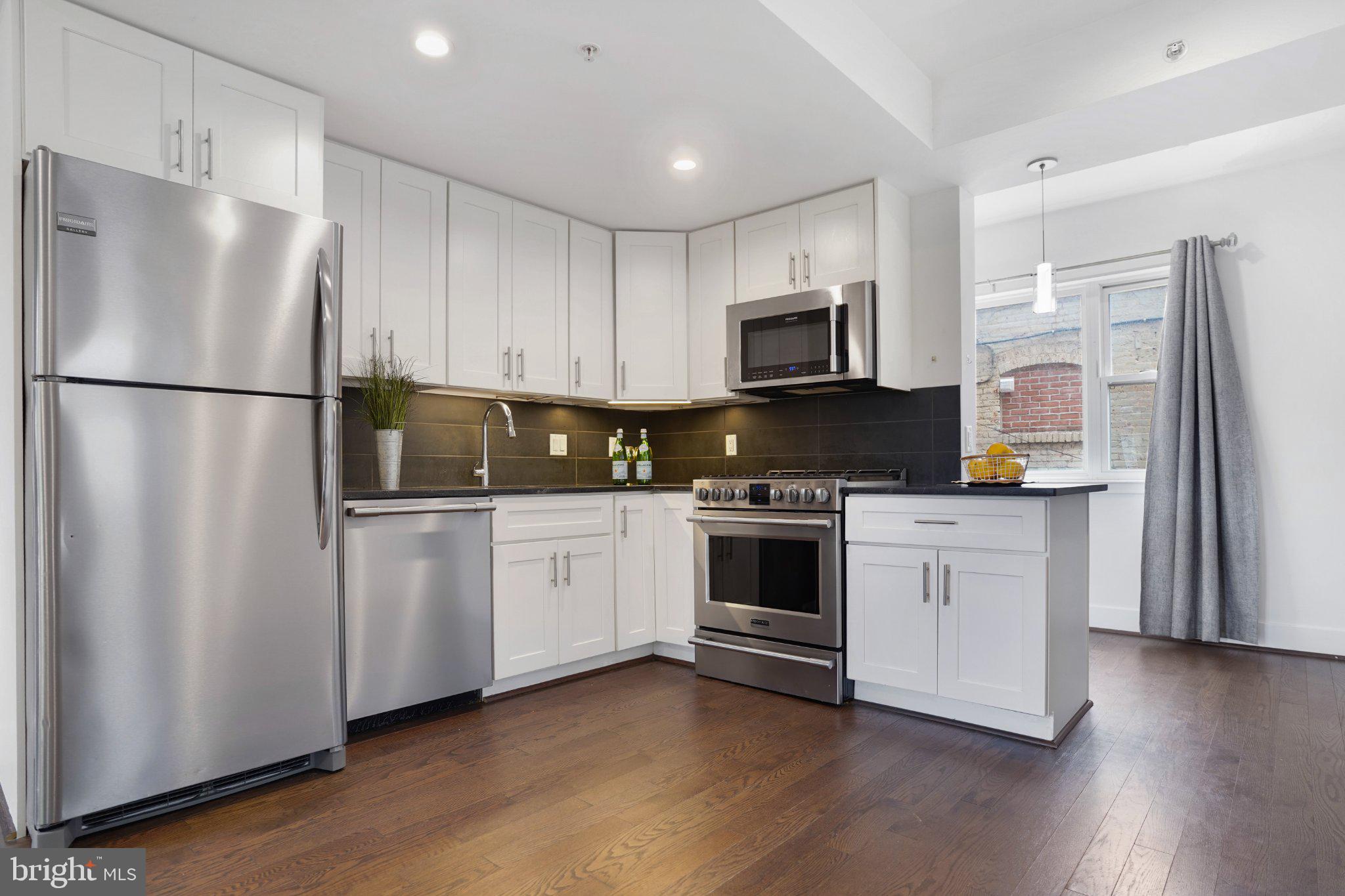 7723 Alaska Avenue Northwest, Unit 103 Washington, DC 20012 - Photo 10 of 12 Modern kitchen with sleek finishes.