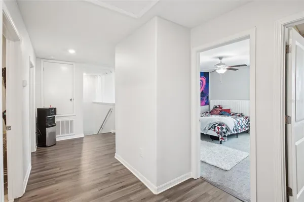 a bedroom with furniture and wooden floor