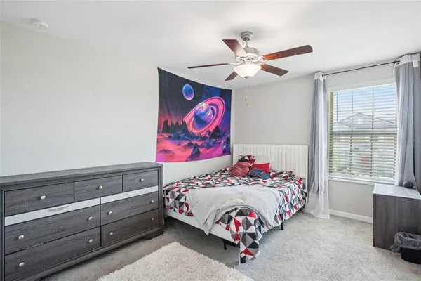 a bedroom with a bed and a window