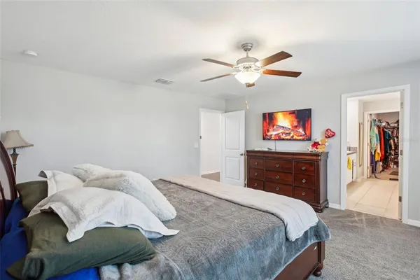 a bedroom with a bed and a chandelier