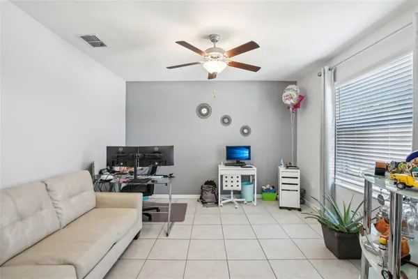 a living room with furniture and flowers