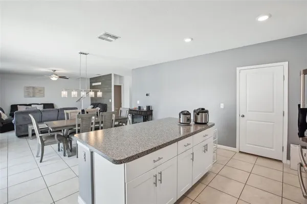 a kitchen with granite countertop a sink appliances and cabinets