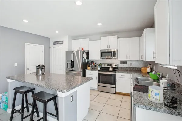 a kitchen with a table and chairs