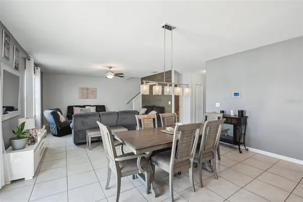 a living room with furniture a dining table and chairs