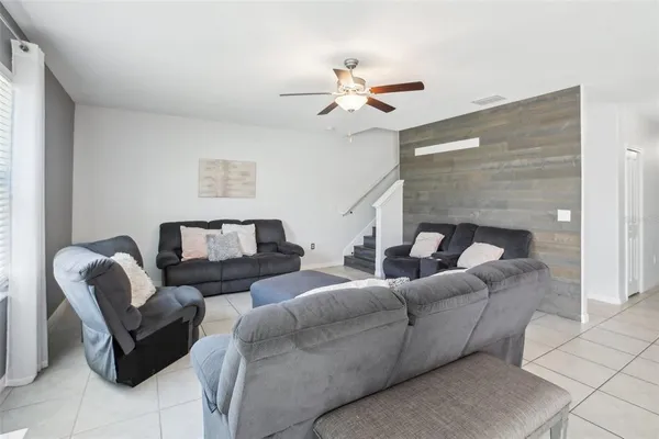 a living room with furniture and a large window