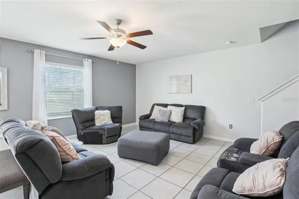 a living room with furniture white walls and a fireplace