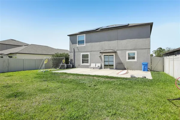 a view of a house with a yard and sitting area