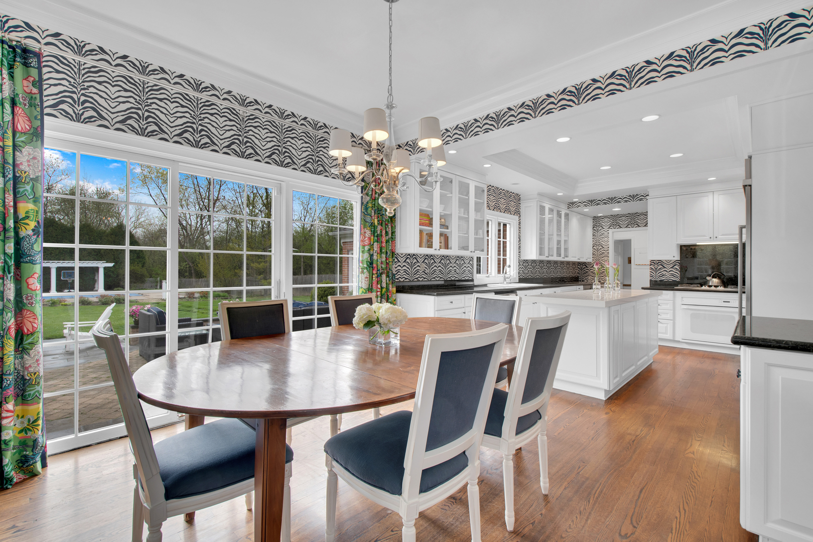 500 Douglas Drive Lake Forest, IL 60045 - Photo 12 of 34 a dining room with stainless steel appliances granite countertop a table chairs and a chandelier