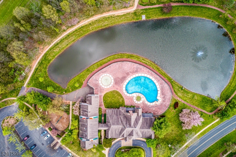 an aerial view of a house with a swimming pool and outdoor seating