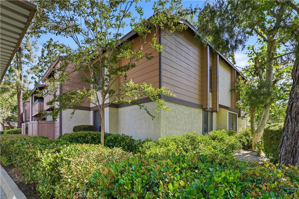 20702 El Toro Road, Unit 231 Lake Forest, CA 92630 - Photo 31 of 36 front view of a house with a tree