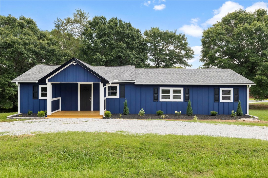 A welcoming front porch enhances this home's bold blue siding and clean lines.