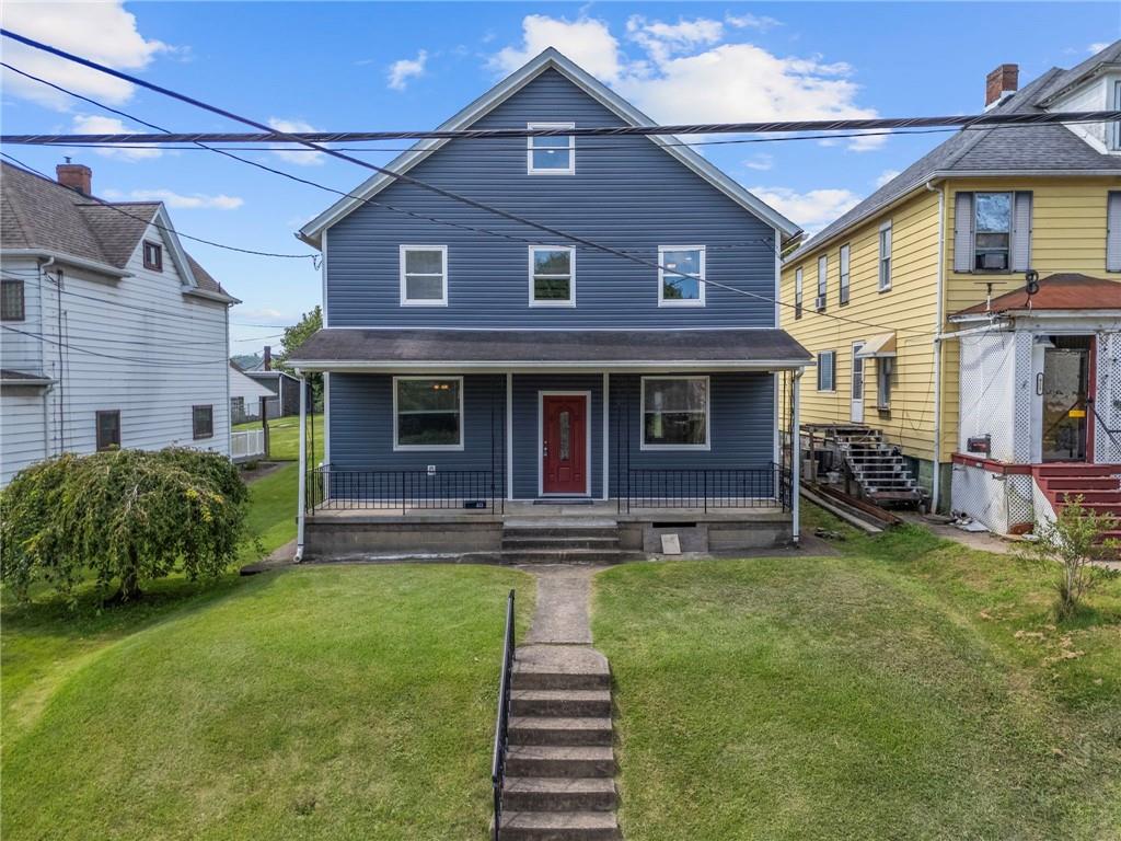 a front view of a house with a yard