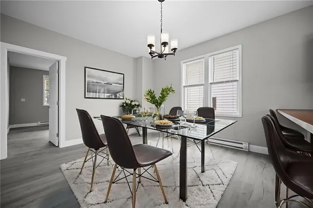 a view of a dining room with furniture and a chandelier