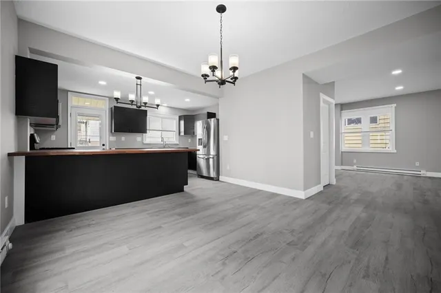 a kitchen with kitchen island a sink stainless steel appliances and cabinets