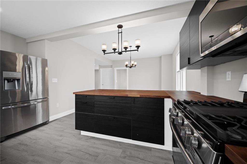 423 2nd Street Donora, PA 15033 - Photo 18 of 47 a kitchen with stainless steel appliances granite countertop a stove and a refrigerator