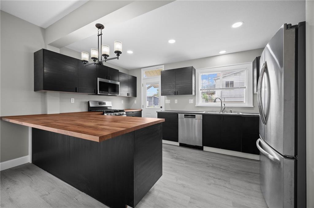 423 2nd Street Donora, PA 15033 - Photo 20 of 47 a kitchen with kitchen island a sink stainless steel appliances and cabinets