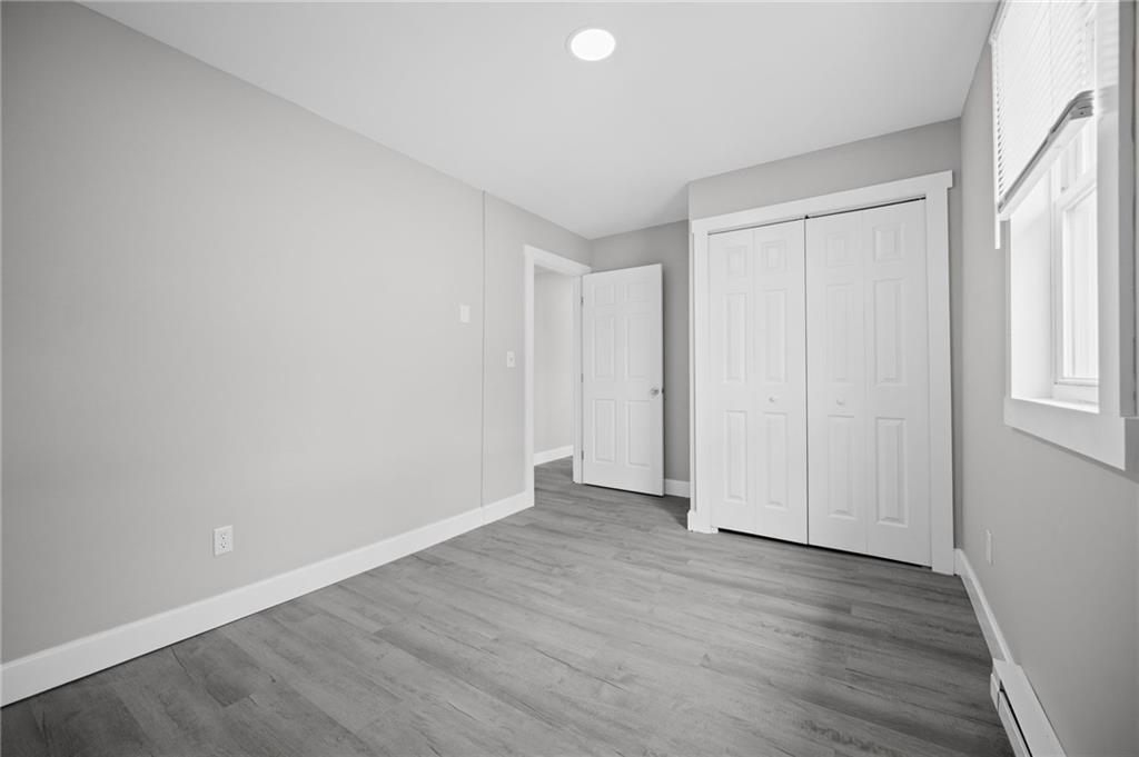 423 2nd Street Donora, PA 15033 - Photo 21 of 47 an empty room with wooden floor and windows