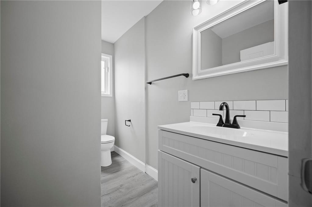 423 2nd Street Donora, PA 15033 - Photo 25 of 47 a bathroom with a sink a toilet and a mirror