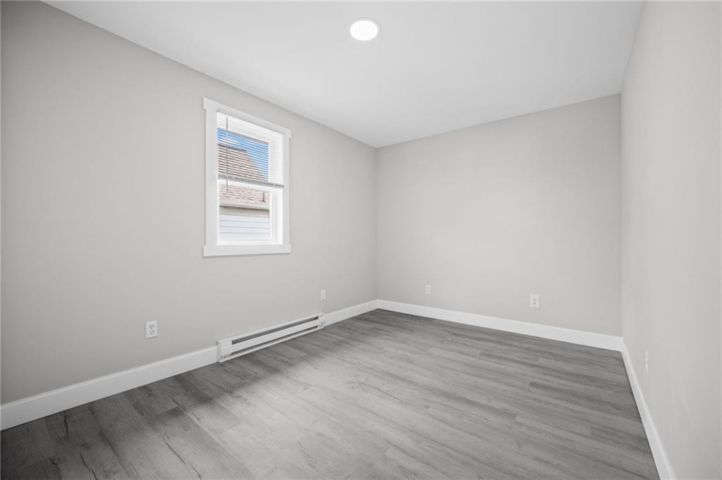 423 2nd Street Donora, PA 15033 - Photo 27 of 47 an empty room with wooden floor and windows