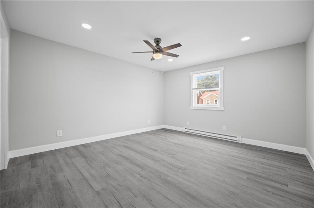 423 2nd Street Donora, PA 15033 - Photo 30 of 47 an empty room with wooden floor ceiling fan and windows