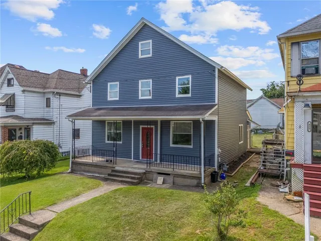 a view of a house with a yard porch and sitting area