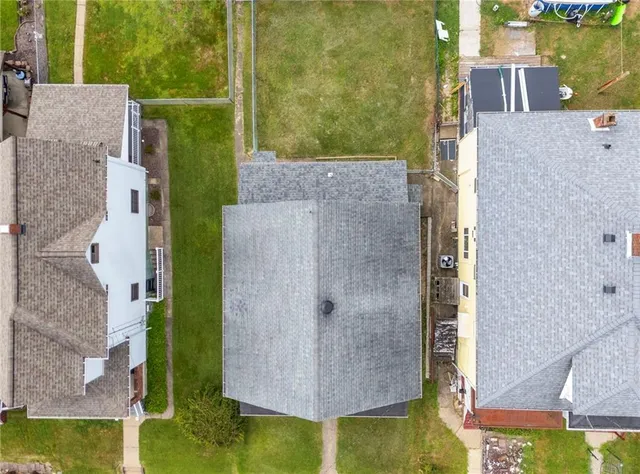 aerial view of a house with pool garden and lake view