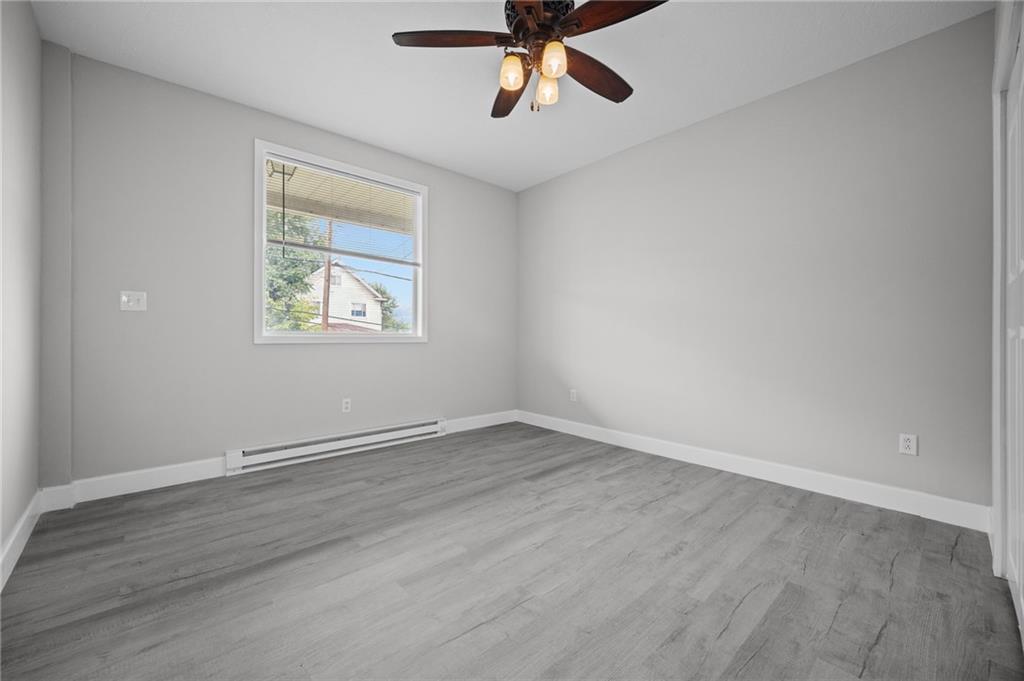 423 2nd Street Donora, PA 15033 - Photo 7 of 47 a view of an empty room with wooden floor and a window