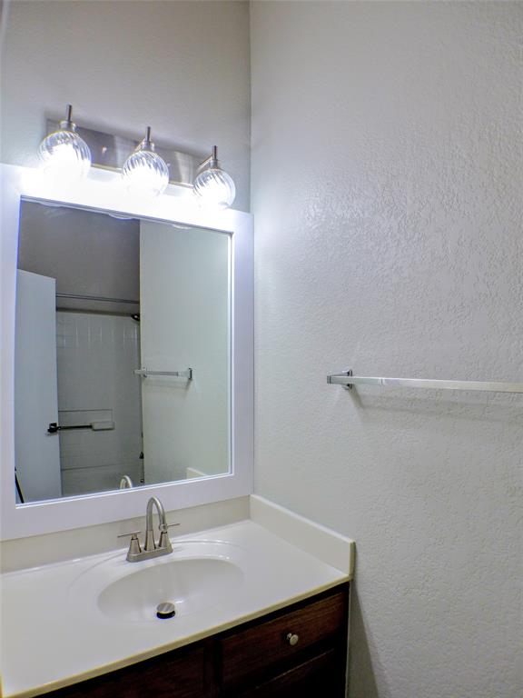 7300 Cresswell Drive Arlington, TX 76001 - Photo 11 of 20 a bathroom with a sink and a mirror
