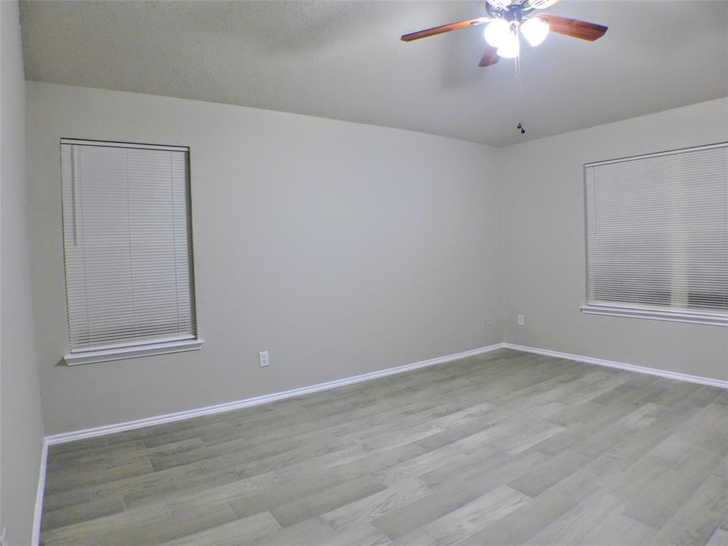 7300 Cresswell Drive Arlington, TX 76001 - Photo 14 of 20 an empty room with wooden floor and windows