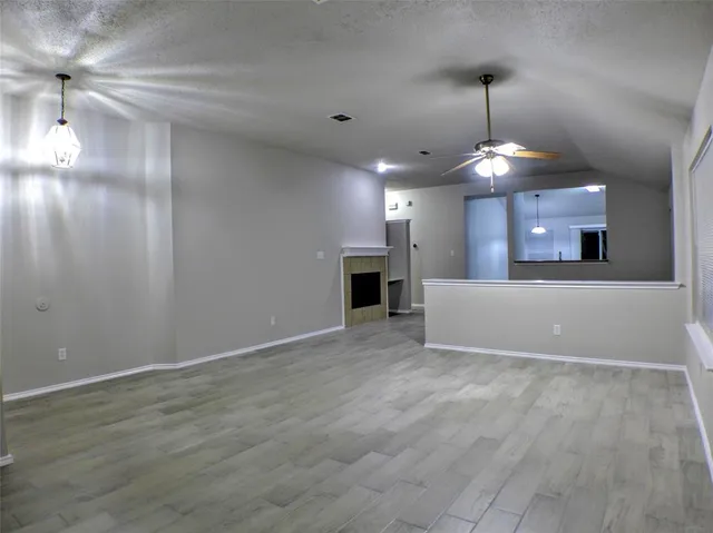 a view of a big room with windows fireplace and chandelier