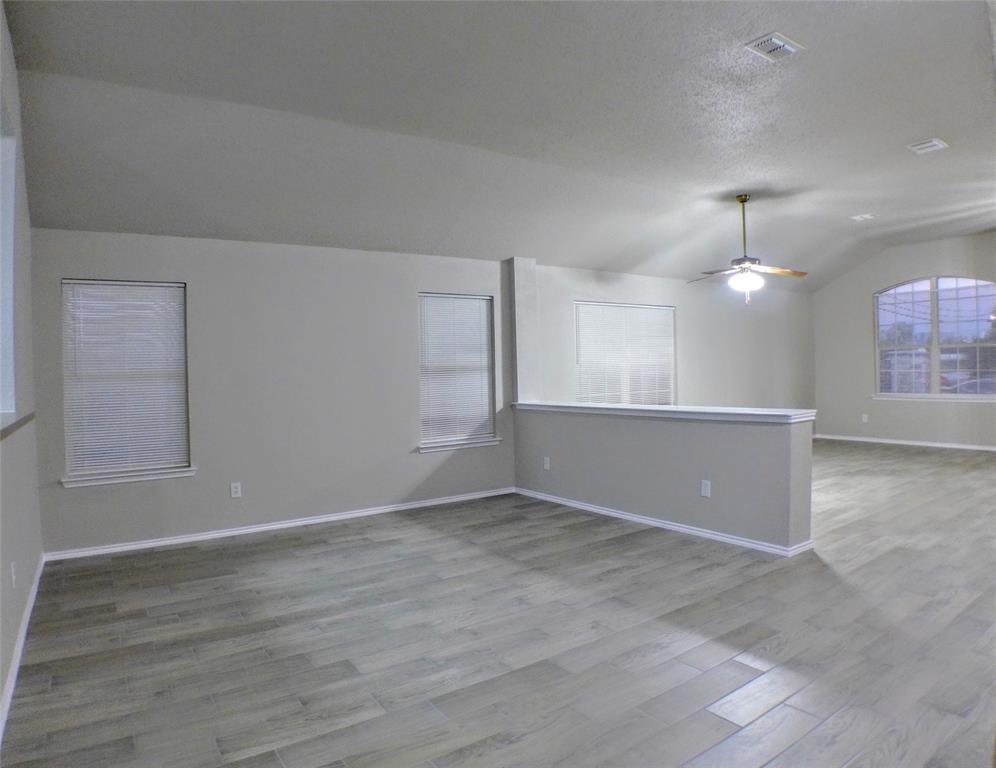 7300 Cresswell Drive Arlington, TX 76001 - Photo 5 of 20 an empty room with wooden floor and windows