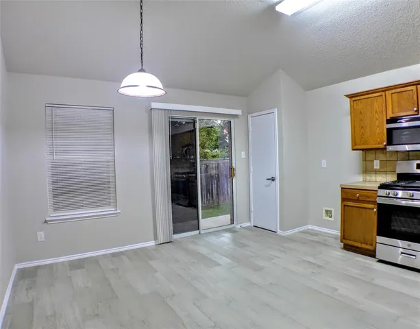 a view of a kitchen with a stove cabinets and a wooden floor